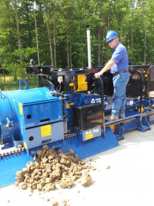 Jim Lee demonstrates the operation of a large auger boring machine.